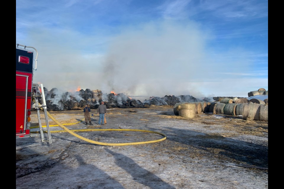 In what the Sundre Fire Department’s chief called an uncommon event, more than 800 straw bales were consumed on Thursday, Jan. 27 by a massive blaze at an Eagle Hill area property that spread quickly after sparking to life in a bale processing machine that is suspected of having suffered a mechanical failure. 
Photo courtesy of Sundre Fire Department 