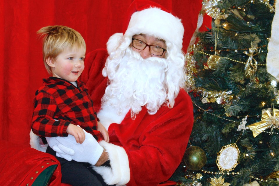 Lane Mercer, 2, seemed happy to visit with Santa and Mrs. Claus, who were at the Sundre & District Museum on Friday, Dec. 3 for photos during Sundown in Sundre events. He was joined by his sister RaeLynn, 4, and parents Lindsay and Ryan, who last spring moved the family to Sundre from southern Ontario. 
Simon Ducatel/MVP Staff