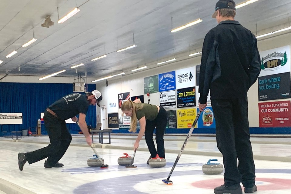 Skip Colby Brian calls the play as teammates Berkley Steffler, third, and Lacey Newsome, lead, sweep a rock into position on Sunday, April 6 during a tight round that ended up tied and going into a draw to the button to determine who would go onto play in the finals right after. The Cremona rink, which also had Jasmine Kirkness playing second, ultimately went onto win the B event final and was one of 32 teams playing in the Sundre Curling Club’s annual open bonspiel, which had started on Tuesday, April 1 and marked the end of the 2024-25 season. Simon Ducatel/MVP Staff