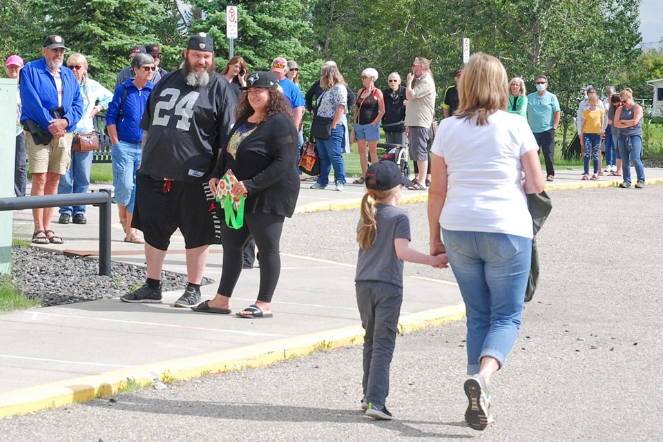 A lengthy line-up formed outside the Sundre Curling Club's rink for the Sundre Farmers' Market on Friday, June 26. As a result of provincial regulations to mitigate the potential spread of COVID-19, organizers implemented a limit on the number of patrons allowed inside the building at any given time. But people were not dissuaded, and patiently waited for their turn to check out the vendors. 
Simon Ducatel/MVP Staff