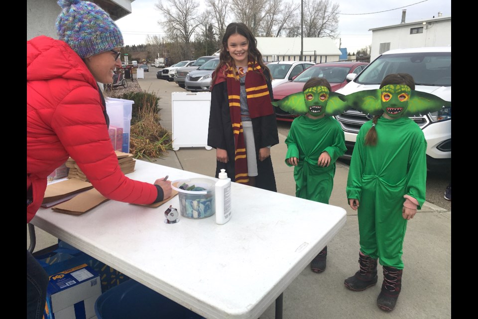 McKenna Milton, 11, dressed as Hermione of House Gryffindor from the Harry Potter series, and her twin six-year-old siblings Charlie and Peyton, dressed up as Gremlins, were among the many youths who enthusiastically attended on Saturday, Oct. 29 a Halloween carnival offering indoor and outdoor activities as well as treats for children at the Sundre & District Museum and historic village grounds. Dan Milton, joined by wife Jade Milton, brought them out to enjoy some pre-Halloween festivities. 
Simon Ducatel/MVP Staff