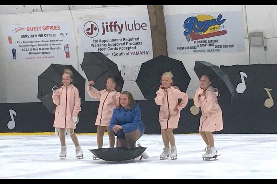 From left: Jillian Dumas, Everly Zinter, Lexi Skage, Tiffany Dumas, and Sadie Zinter pose with their umbrellas after finishing up a routine they danced to a song called I Love a Rainy Night. 
Simon Ducatel/MVP Staff