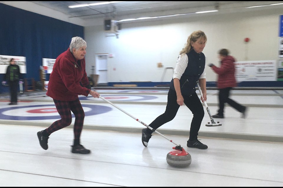 Skip Renee Gibson, from Sundre, prepares to release a rock on the afternoon of Saturday, Feb. 12 during the Sundre Curling Club's ladies' bonspiel, with second Kris Burkholder, who is also the president of the Sundre Curling Club, alongside.
Simon Ducatel/MVP Staff