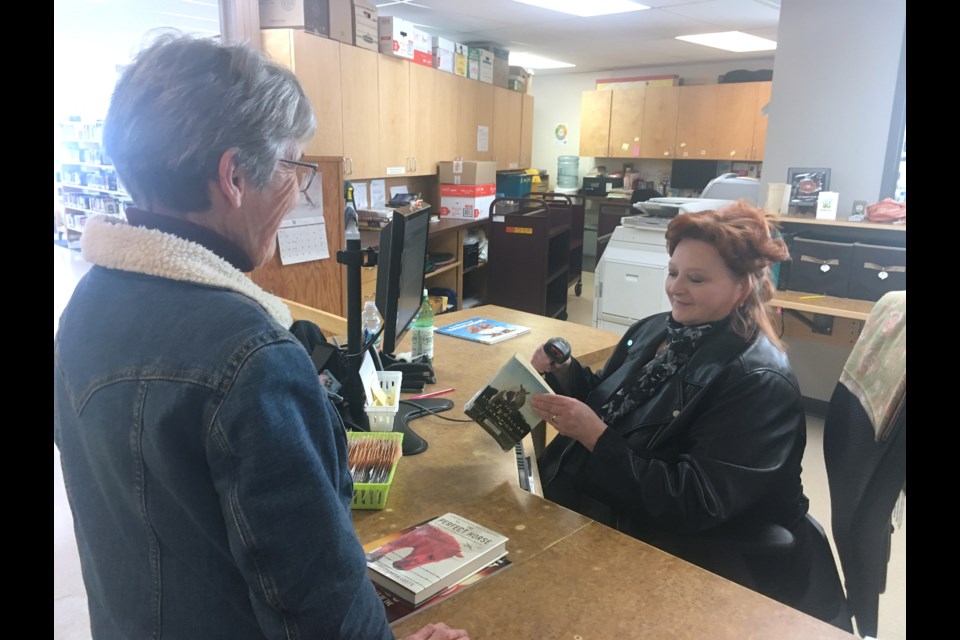Marilyn Walker, Sundre library member and volunteer, checks out some items on Thursday, Nov. 23 with some help from library assistant Sandra Huchala. Council heard at the regular Monday, Nov. 20 meeting during a presentation from library manager Joy Willihnganz that while the number of memberships has not yet fully recovered, overall circulation – or the total amount of items checked out – has since 2022 soared past pre-pandemic levels. 
Simon Ducatel/MVP Staff