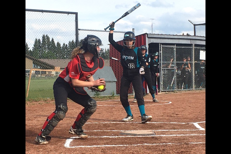 The Sundre Minor Ball U13 Red Devils softball squad played Thursday, June 17 on home turf against the Sylvan Lake Storm. Here, catcher Emma Coleman reacts quickly after recovering a pitch that went wide to keep one of the players from Sylvan Lake on second base. The teams were evenly matched with a nail-biting 14-13 final score for Sundre. 
Simon Ducatel/MVP Staff