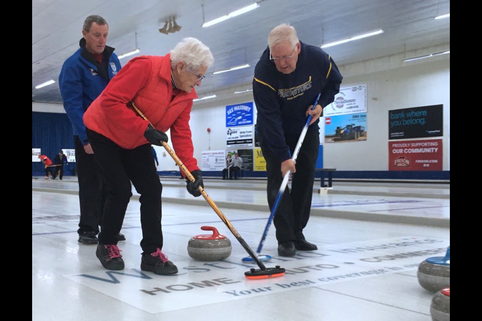 Second Doug Haynes, right, and lead Audrey Head sweep home a rock with team skip Gary Head keeping a watchful eye out on the play.
Simon Ducatel/MVP Staff