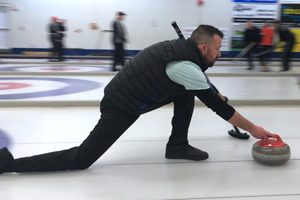 Tyson LeBreton carefully lines up a shot on Saturday, March 12 before releasing a rock. The Sundre Curling Club was a busy place over the past weekend when the Sundre Oilmen’s Association hosted its annual bonspiel. 
Simon Ducatel/MVP Staff