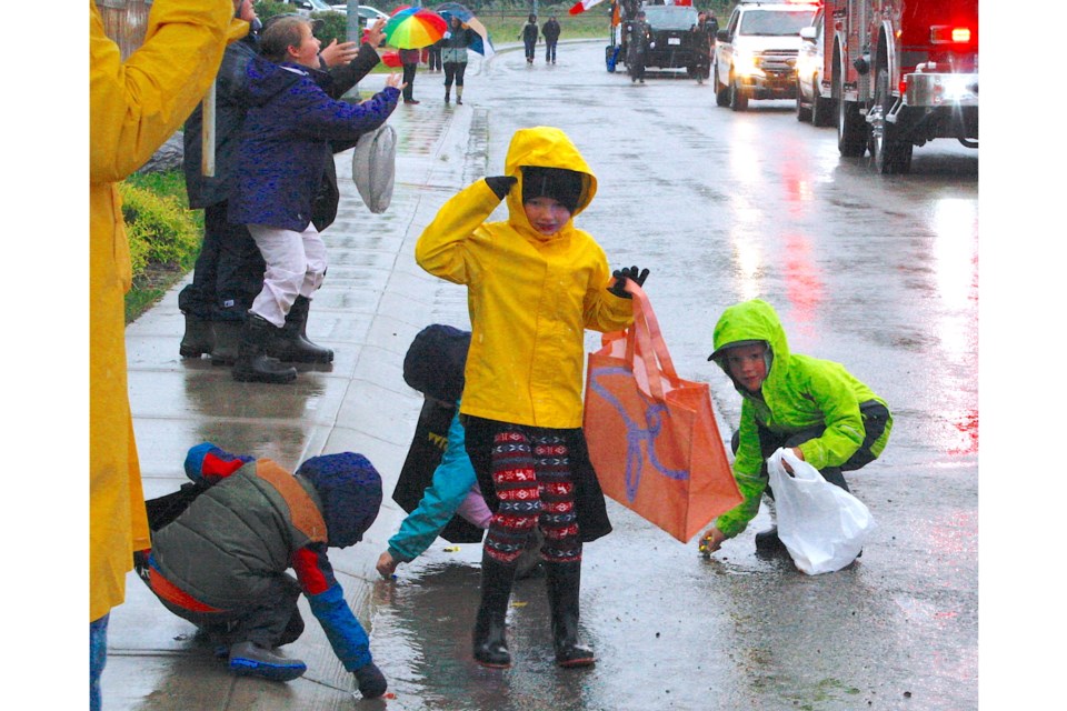 Rain jackets and rubber boots were more than enough for children to face the cold, wet weather on Saturday morning during the annual Sundre parade; although the rain did not seem to dampen their enthusiasm one bit as they eagerly scooped candy off the street. Simon Ducatel/MVP Staff