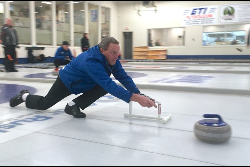 Gary Head, playing second for an Olds rink skipped by Sterling Mcleod, is eyes on the prize as he releases a rock on Friday, Dec. 8 during the Sundre Curling Club’s annual seniors bonspiel finals.
Simon Ducatel/MVP Staff