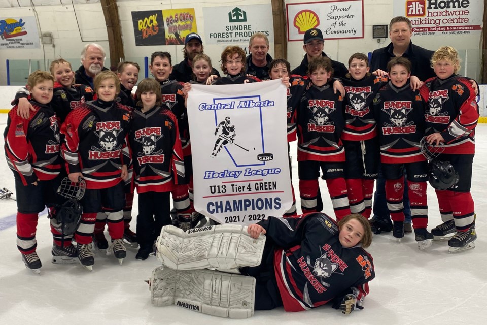 ZONE CHAMPS — The Sundre U13 Huskies proudly held up on Saturday, March 12 the championship banner for the tier 4 Central Alberta Hockey League division. The team will once again be back on home ice later this month when they host provincials. 
Submitted photo