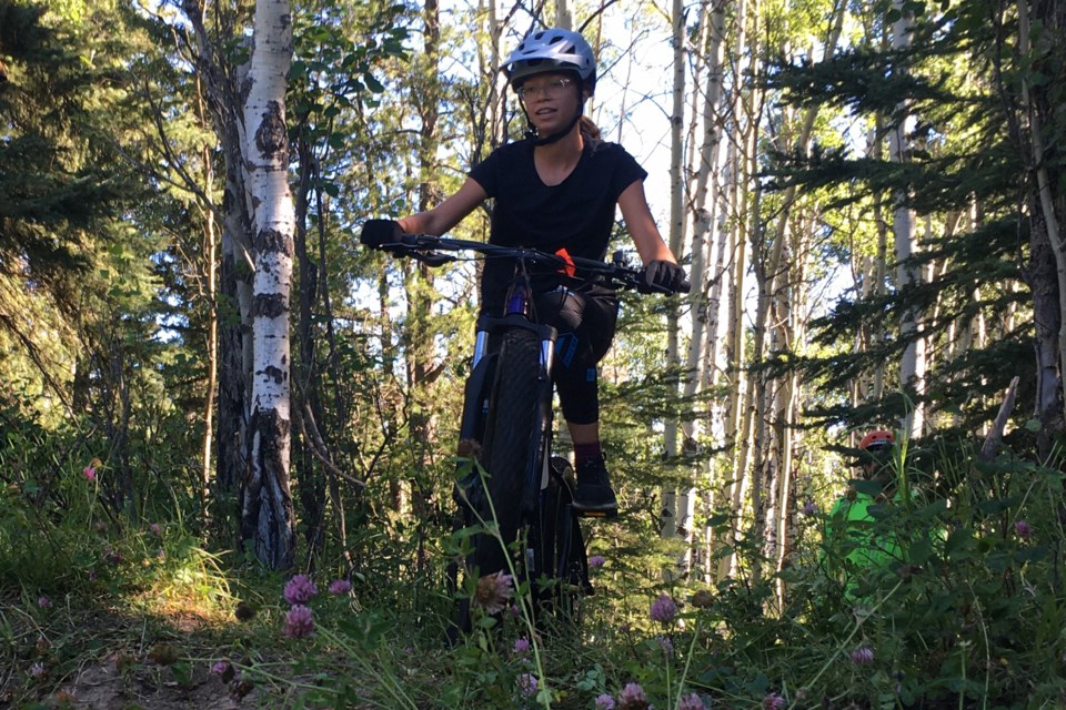 Megan Homan, 13, was among more than two dozen youths who on Saturday, Aug. 6 enthusiastically participated in a training trial introducing riders to more technically challenging terrain features on Sundre’s Snake Hill in anticipation of competitions. She for the first time came out from Red Deer with her parents Melanie and Dwayne, and they hope to once again return next year. 
Simon Ducatel/MVP Staff