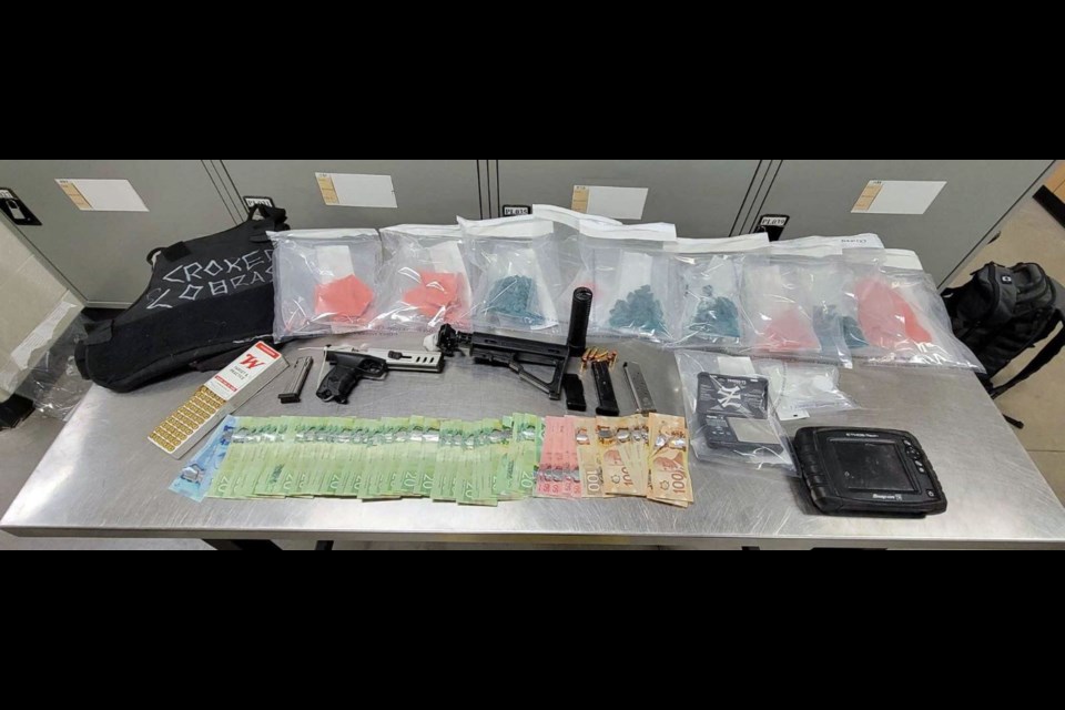 Weapons, money and drugs that were recently seized by ALERT and RCMP; a case that involves a suspect in the May 29 robbery of Innisfail's Super 8 Hotel.  Submitted police photo