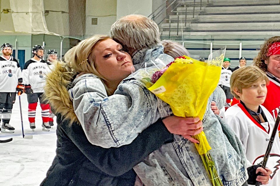 Bailey Quirico, the mother of the late Tyler Haarstad's three children, receives a heartfelt hug from former Eagles coach Brian Sutter on Feb. 25 at the Innisfail Arena during a tribute for the former Innisfail Eagles hockey player who passed away on June 9, 2022. 
Johnnie Bachusky/MVP Staff