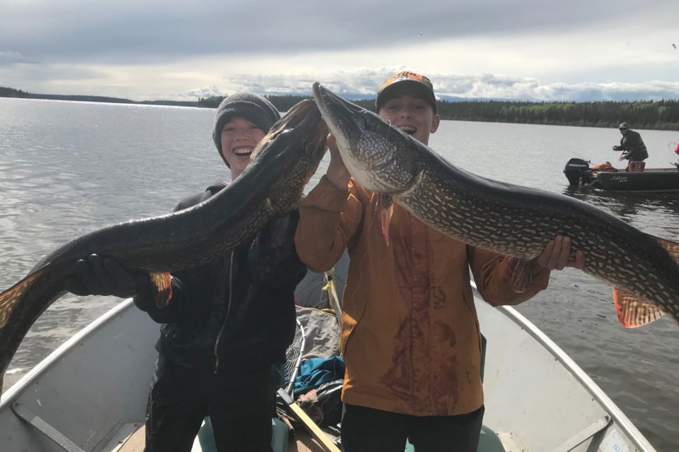 Gavin and his brother Alec Johnson, from Didsbury, who came out with their father Jeff Johnson, hoist a huge pike they later released. 
Submitted photo