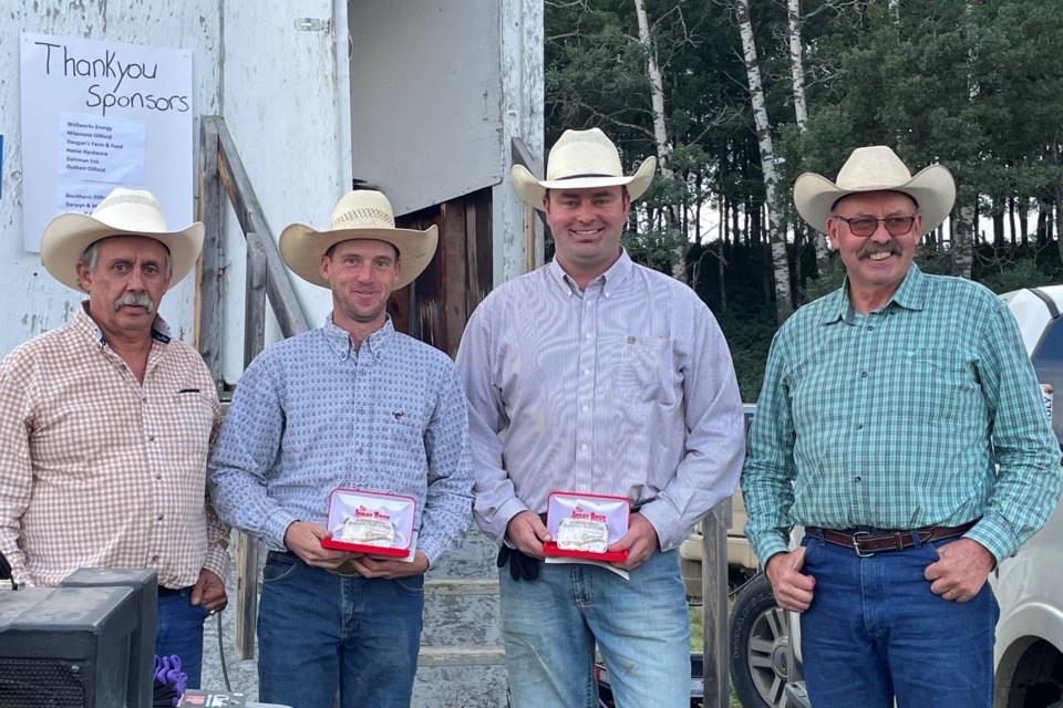 Flanked by brothers Glen, left, and Jim Smith, right, who were representing the Smith family, are first place winners Craig Lynch and Luke Smith. 
Submitted photo