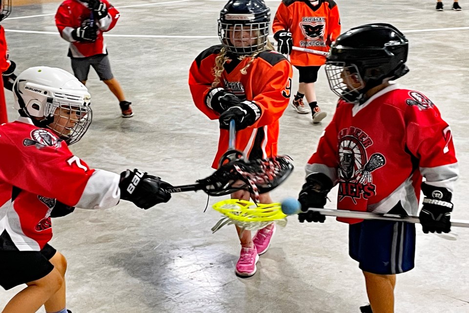 An Innisfail Phantoms player from the U7 team, centre, battles a pair of Red Deer Chiefs for possession during a game at the 7th annual Terror of the Tykes Lacrosse Festival at the Innisfail Twin Arena on May 13. The festival attracted 25 teams and more than 300 young players from across Central Alberta.
 Johnnie Bachusky/MVP Staff