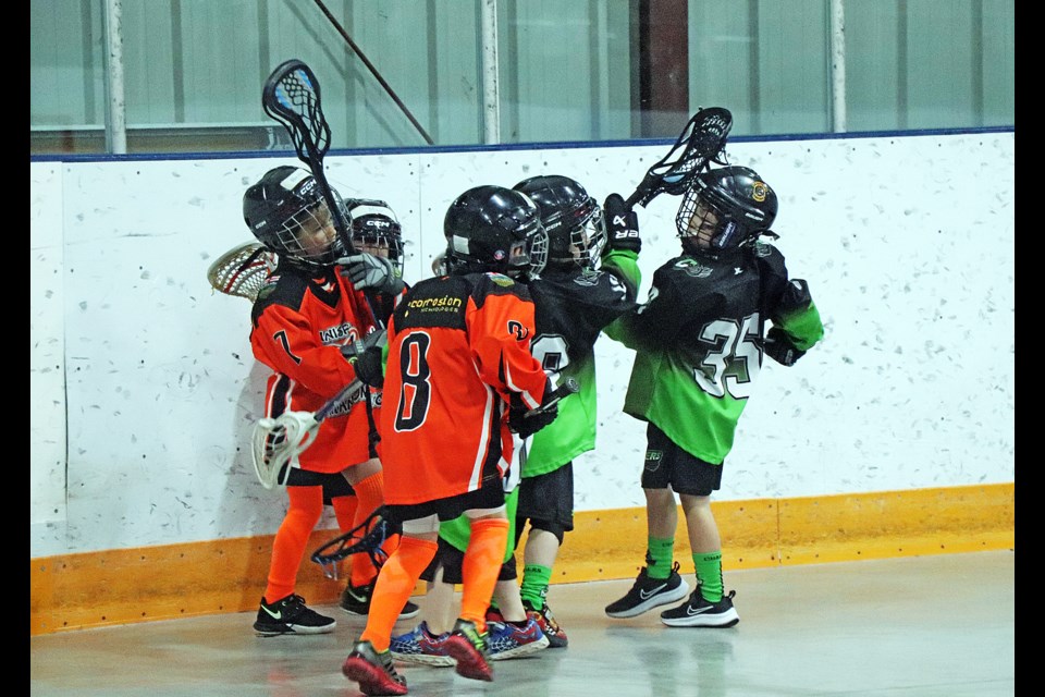 Young U7 lacrosse players from the Innisfail Phantoms (left) and the Chargers battle along the boards during a game at the 10th annual Terror of the Tykes Lacrosse Festival on May 10 and 11 at the Innisfail Twin Arena. Johnnie Bachusky/MVP Staff