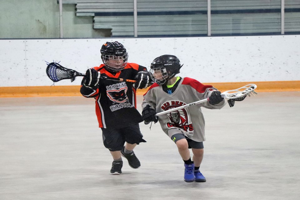 An Innisfail Phantom player (left) chases down a Red Deer Chiefs opponent during an afternoon U8 game at Innisfail's Terror of the Tykes Lacrosse Festival on May 14. Johnnie Bachusky/MVP Staff