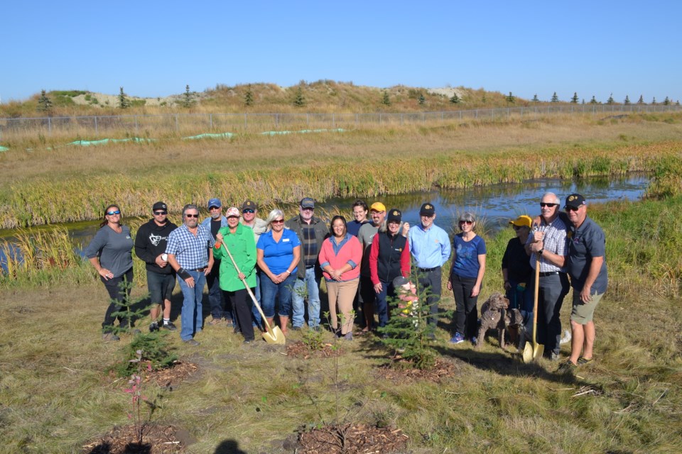 Participants of the tree and shrub-planting ceremony pose for a photo.