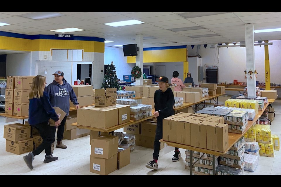 Members of the U15 Huskies were on the evening of Wednesday, Nov. 23 busy unloading food from a trailer destined to supplement the Sundre Santas holiday hamper program. 
Submitted photo
