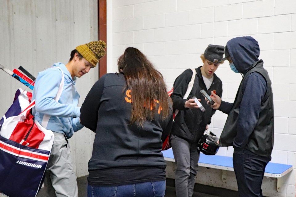 Town of Innisfail staff members screen players from the Innisfail Mens Rec League for proof of vaccination during the evening of Nov. 25 at a special entrance door to the Arena. 