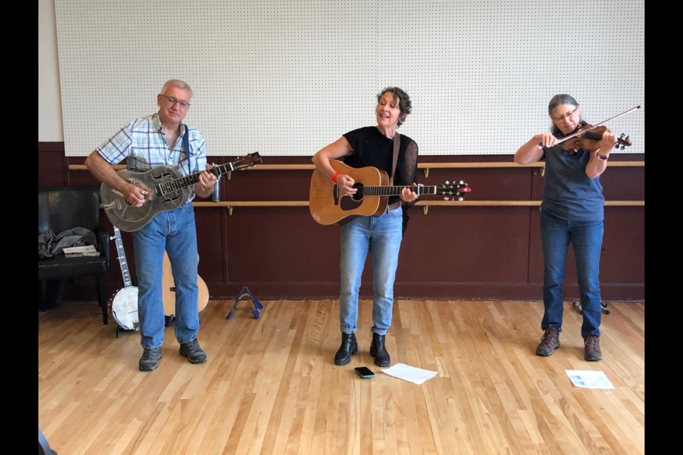 Christie Simmons, centre, and bandmates Helen and Steve Goodchild perform her original acoustic songs in the historic Water Valley school house. 
Dan Singleton/MVP Staff