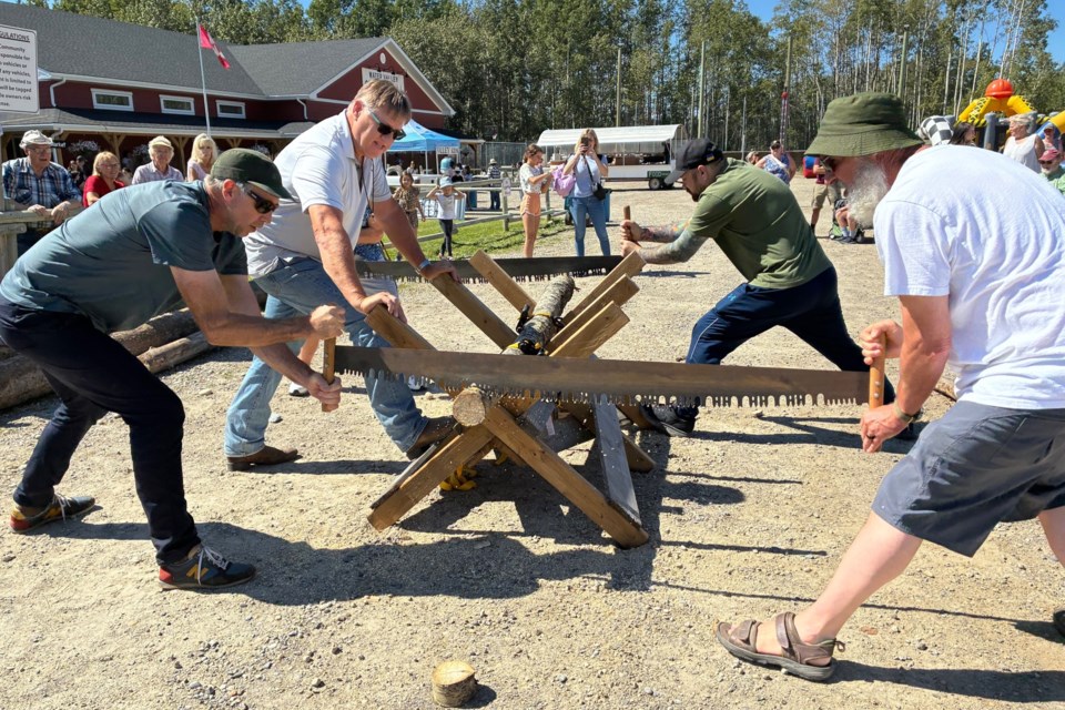 Competitors take part in the log sawing competition during Water Valley Days on Saturday.