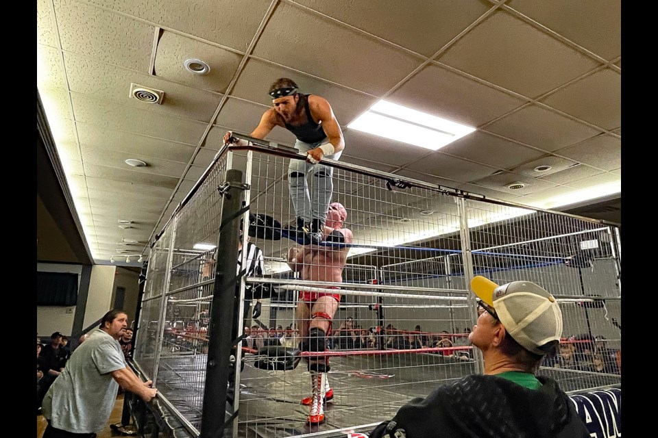 “Mr. Beefy Goodness” Vance Nevada chased “Prospector” Wes Barker up the corner of the steel caged ring during CanAm Wrestling action on Nov. 17 at the Innisfail Royal Canadian Legion Branch #104. Johnnie Bachusky/MVP Staff