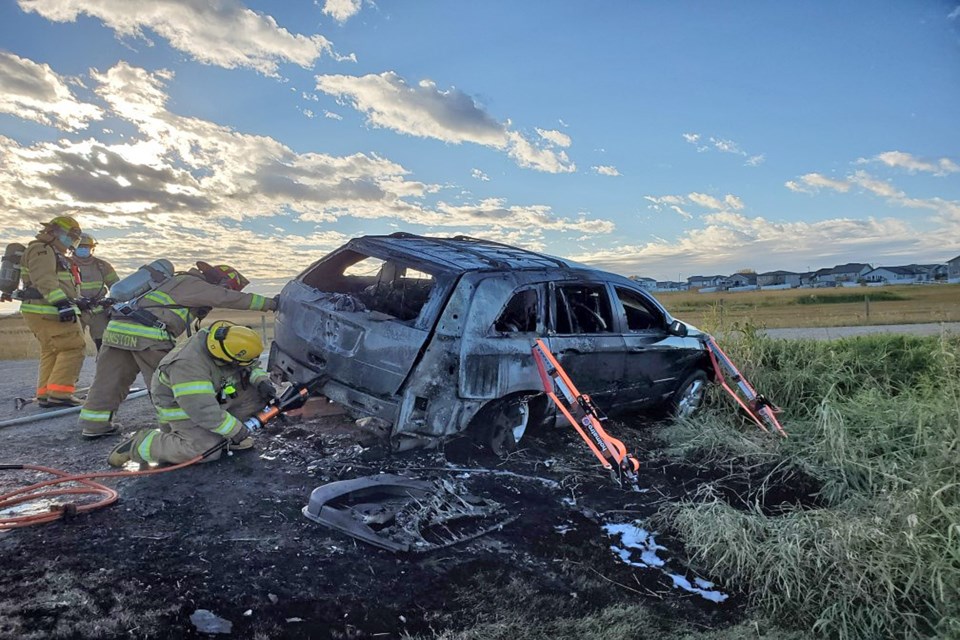 Penhold firefighters at work putting out a vehicle fire late Tuesday afternoon (Sept. 29) on Waskasoo Avenue. Submitted photo