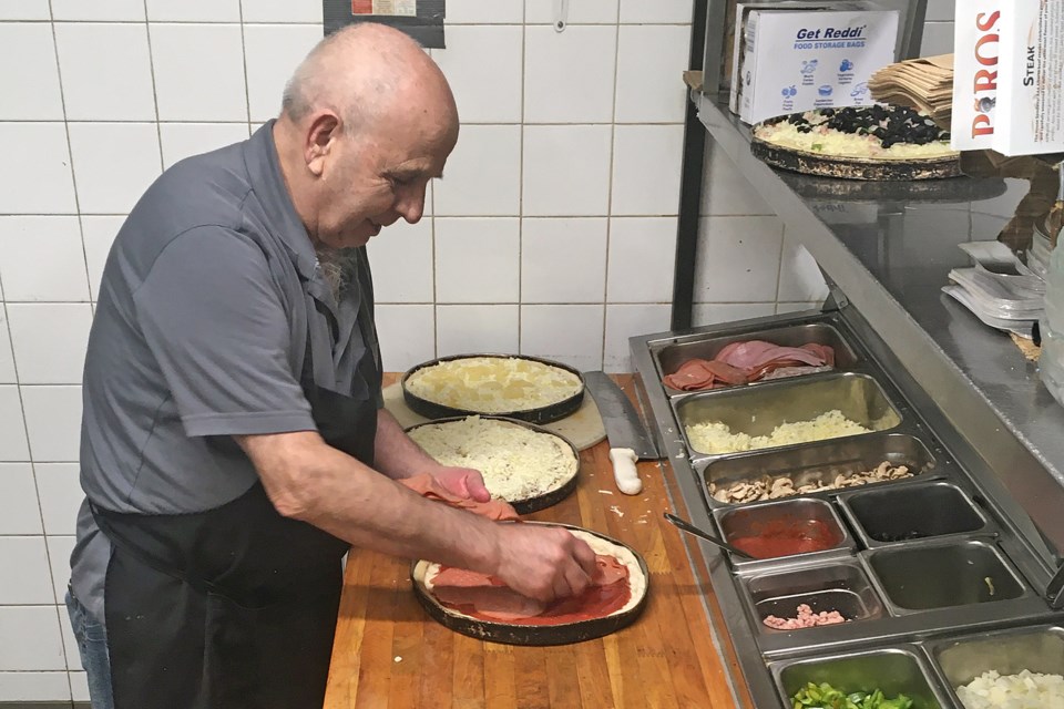 George Mitsuolas, who alongside wife Helen runs Piros Family Restaurant in Sundre, prepares on Wednesday, May 13 an order of complementary pizzas for staff at the Sundre Hospital and Care Centre.
Simon Ducatel/MVP Staff