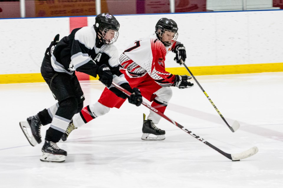 Sundre Husky Wyatt Thengs puts pressure on a player from Clive on Saturday, Feb. 22 at the Sundre Arena during the second game in the best-of-three semifinal series in the Central Alberta Hockey League's bantam tier 4 division. 
Photo courtesy of Image by Maila