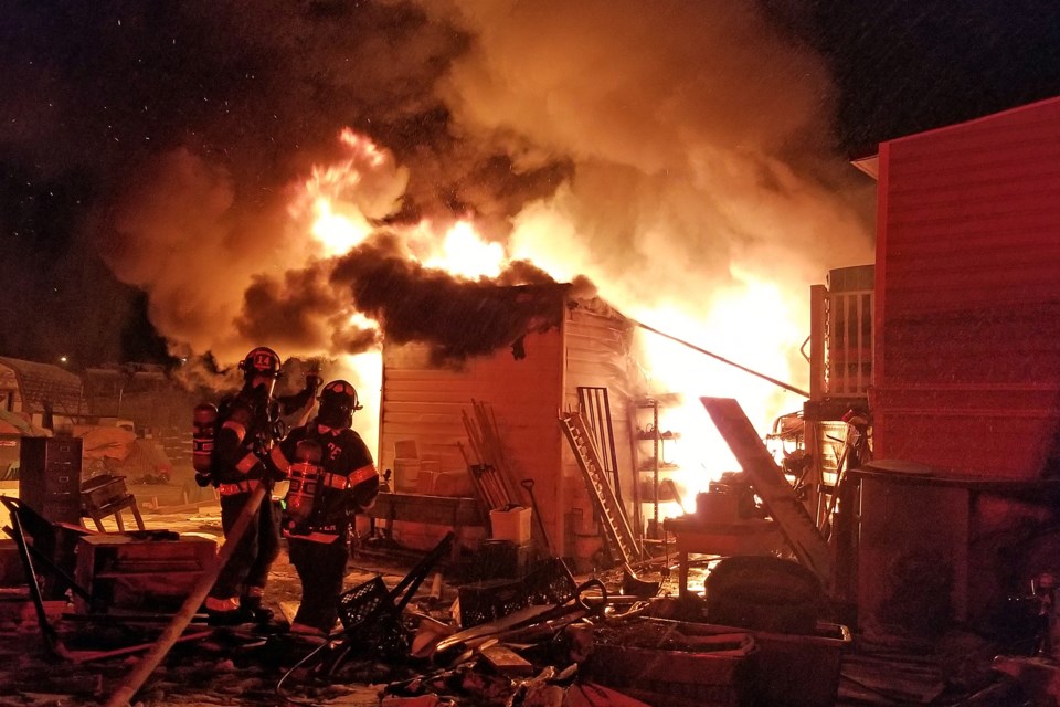 Volunteer members of the Sundre Fire Department responded quickly during the early morning hours of Tuesday, Nov. 19 to a structure fire on the west side of 10th Street SW across the road from the Candre facility.  Firefighters successfully prevented the flames from a fully engulfed shed from spreading to the adjacent home.  
Courtesy of Tammi Johnson