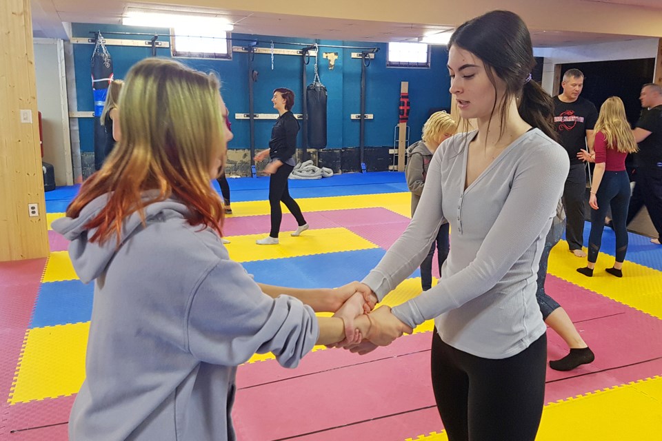 Sundre High School Grade 12 student and Leo club member Carmen Wolfe, right, practise how to break free from a wristlock with classmate Justice Dach during Youth Empowerment Day.
Submitted photo 