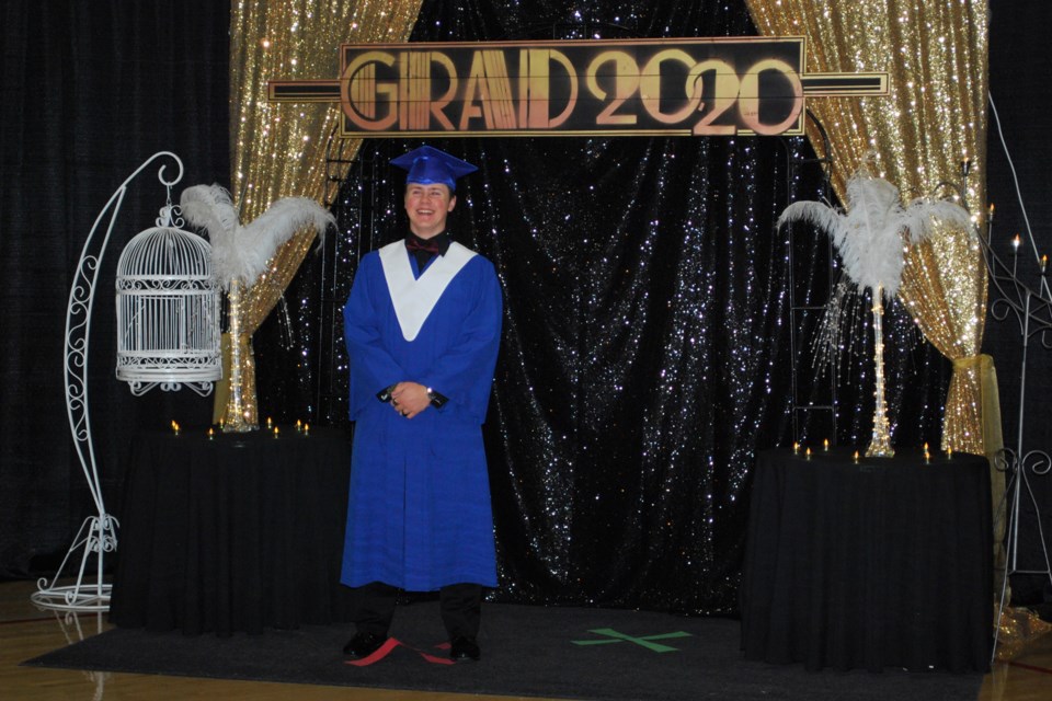 Cayd Neilly stands in front of the Great Gatsby'-themed decorations for photographs. Photo by Karen Fagan.