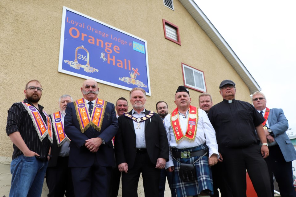 Members of the Innisfail Orange Lodge gather outside their revamped hall during their open house on Sept. 12.  Johnnie Bachusky/MVP Photo