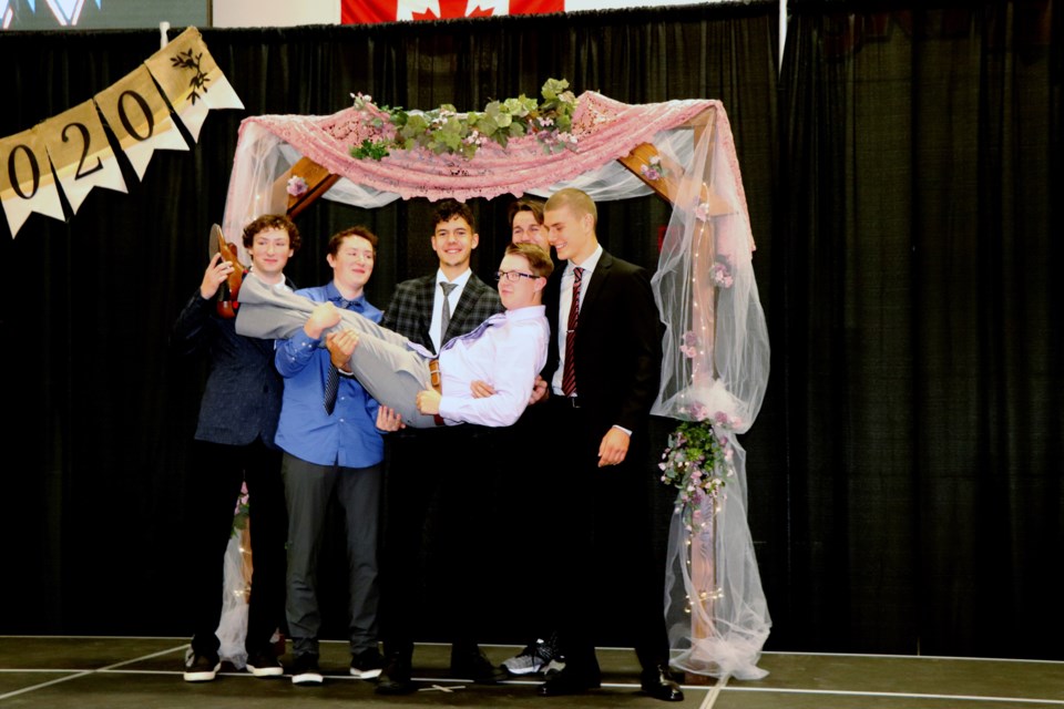 A group of Penhold graduates let loose with a celebration photo pose following the ceremony. Johnnie Bachusky/MVP Staff