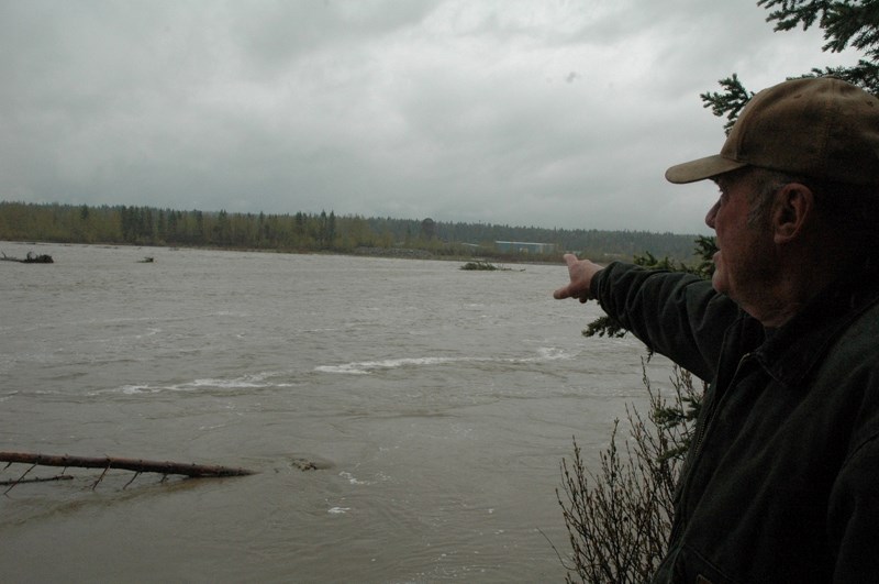 John Poirier looks over the roaring Red Deer River in Sundre&#8217;s south end.