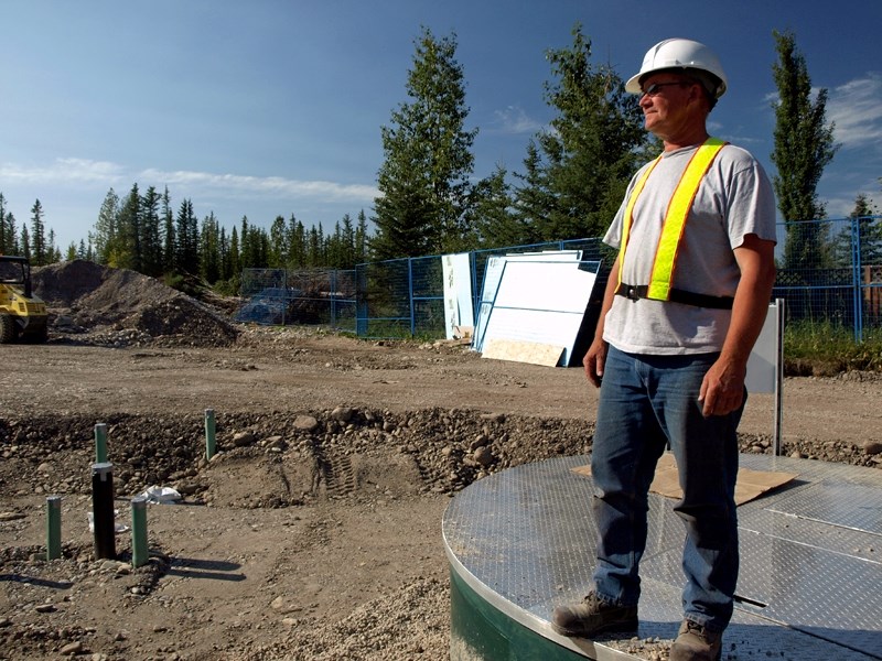 Ralph Welzel, civil supervisor for Tritech Group Ltd., surveys the construction site for the lift station on the east side of the Red Deer River, where new water and