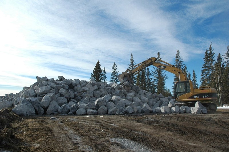 Crews move rocks along the Red Deer River