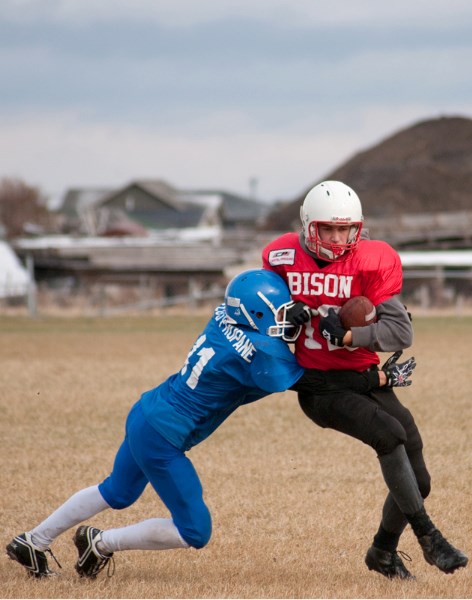 Bison Tom Smit pushes hard against Didsbury Dragon David Aebersold in the second half.