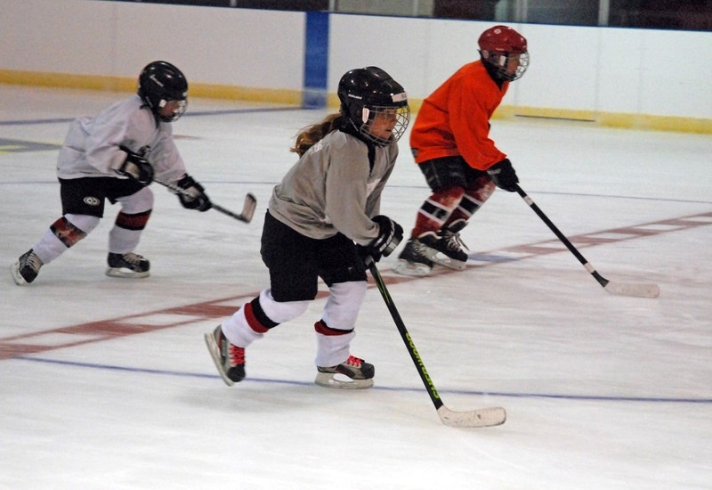 The novice Sundre Huskies hit the ice for practice early this season. Pictured doing some drills are Ava Croteau in the foreground with Levi Hunter, left, and Isaac Thengs.,