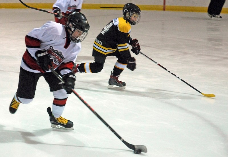 Tatum Mitzel works the puck up the ice during the first of three games the Sundre atom B Huskies played during their annual tournament held Jan. 8-10 at the Sundre arena.,