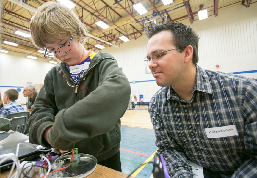 STUDENT SCIENTISTS ó River Valley School Grade 4 student Colin Newsham presents his project entitled Simple Circuits to judge William Knelson during the school&#8217;s