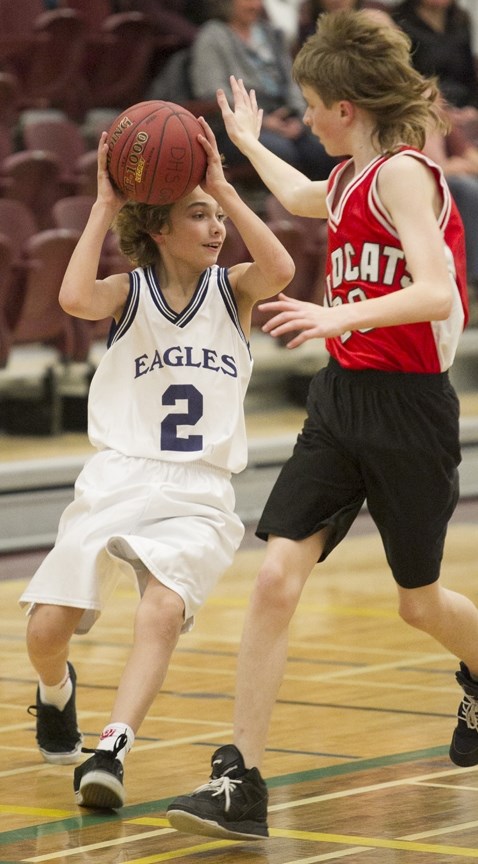 LOOKING TO PASS ó River Valley School Eagles middle A basketball player Adam Cottrell looks for a pass during the Eagles&#8217; game against the Westglen School Wildcats at