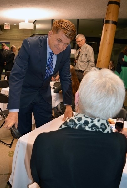 Wildrose Leader Brian Jean speaks with Mabel Hamilton, one of many local and area residents who attended a party fundraiser at the Innisfail Library/Learning Centre on