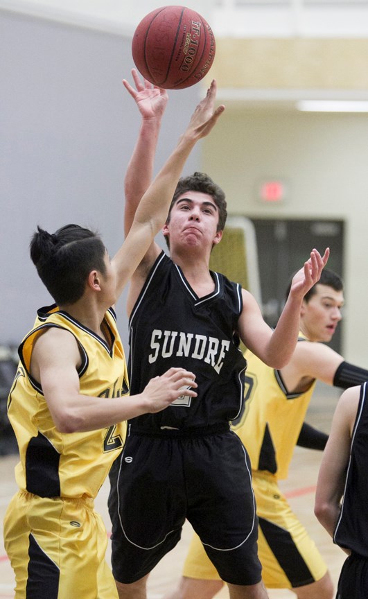 ON THE OFFENCE ó Sundre High School Scorpions junior varsity basketball player Dan Kamaleddine attempts a shot during the Scorpions&#8217; game against the Olds High School