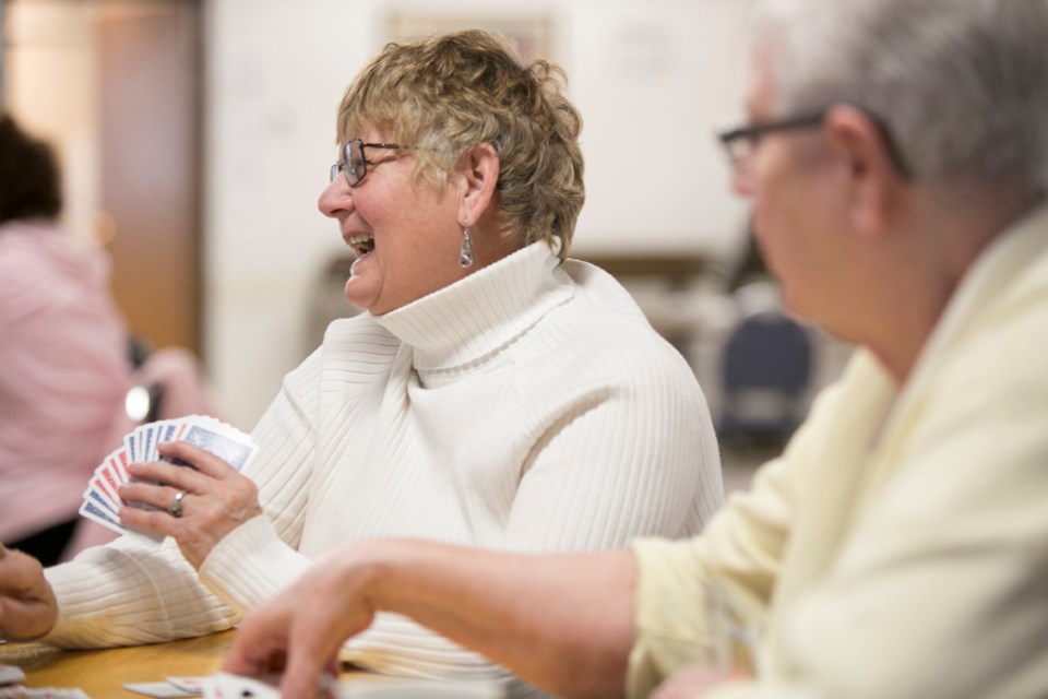 SHARING A LAUGH OVER A GAME OF CARDS ó Verna McFadden laughs while playing canasta at the West Country Centre on Tuesday, Feb. 2.,
