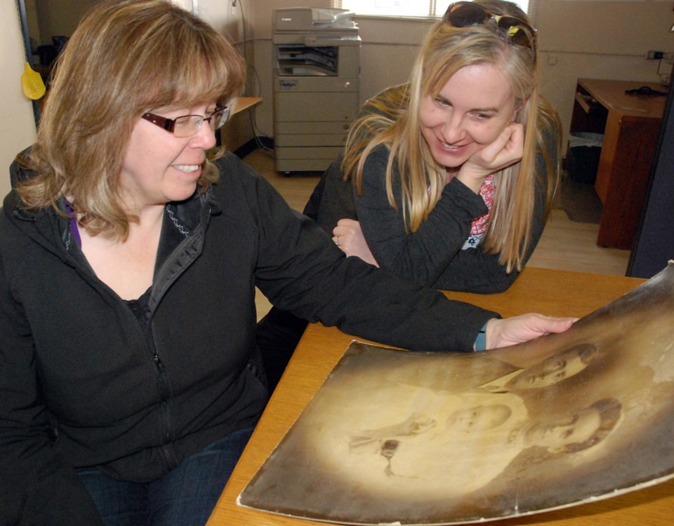 Caroline resident Donna Gustaw, left, sees in person for the first time on Tuesday, March 1 an old photo of her great-grandparents that was found during renovations at the