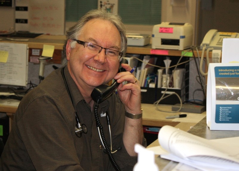 Dr. Hal Irvine beams a million-dollar smile while behind the counter at the Sundre Hospital and Care Centre&#8217;s accute care nursing station in November 2011.,