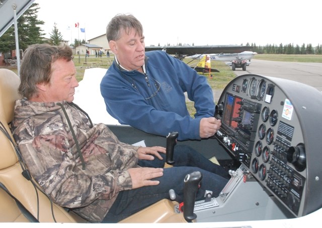 Randy Newsham and his son Riley, who live north of Sundre, take a look at one of several helicopters that landed at the airport for the Sundre Flying Club&#8217;s annual